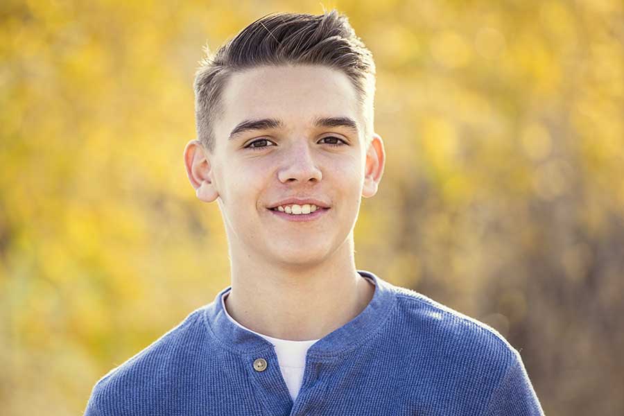 teen boy smiles at adolescent rehab program
